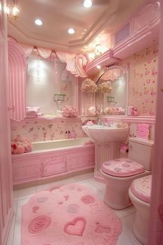 a bathroom decorated in pink and white with hearts on the floor, rugs and walls