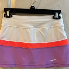 a women's nike tennis skirt hanging on a wall