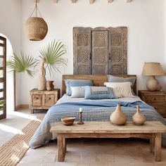 a bed room with a neatly made bed and two vases on the end tables