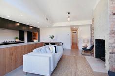 a living room filled with furniture and a fire place next to a wall mounted tv