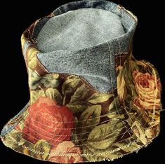 a hat that is made out of fabric and has flowers on the front, with mesh netting