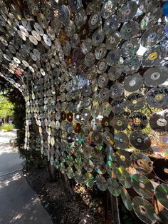 many cds are stacked on top of each other in the shape of a peacock's tail