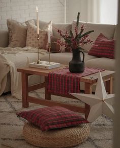 a living room filled with furniture and a star pillow on the floor next to a coffee table