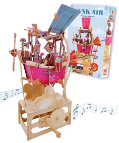 a wooden model with musical notes surrounding it and an image of a pink wagon filled with toys