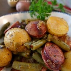 a white plate topped with potatoes, green beans and kielbasa hashbrowns