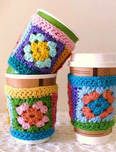 crocheted coffee cups sitting on top of a table