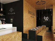 a restaurant with black walls and wooden tables