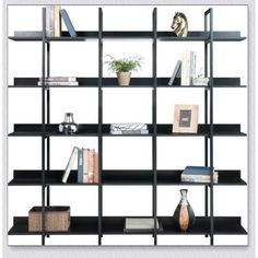 a black book shelf with books and vases on top of it in front of a white background