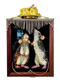 two mice in a wooden frame with beads