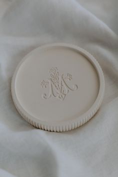 a white plate sitting on top of a bed