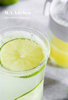 a glass filled with lemonade and lime slices