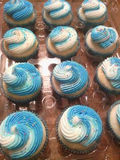 cupcakes with frosting and sprinkles in a clear plastic tray