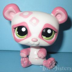 a close up of a small toy animal on a blue background with pink and white colors