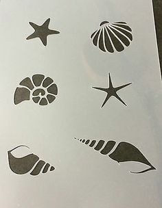 several sea shells and starfish stickers on a piece of white paper with black ink