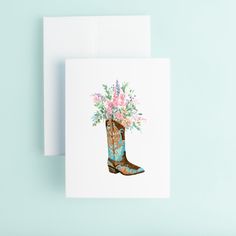 a card with a cowboy boot and flowers in it on top of a blue background