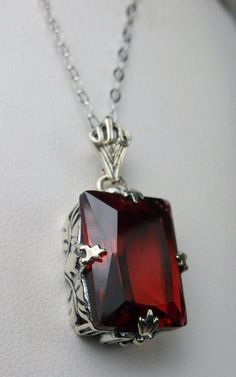 "Simulated Red Ruby Pendant & Earrings GL Design#15 Custom Made Pendant (P15) This is an Art Deco style sterling silver filigree 10 carat Simulated/man-made red ruby pendant necklace. The beautiful rectangle-cut ruby gem is 16mm x 12mm. The 1.5mm necklace chain (if chosen) is adjustable from 18\"-20\". The entire pendant is 1 1/8\" long by 9/16\" wide. Notice the beautiful craftsmanship of the silver Art Deco filigree bail. The earrings are 16mm x 12mm each and 1 5/16\" long. The dazzling ge Fine Gemstone Jewelry For Valentine's Day, Fine Jewelry Gemstone For Valentine's Day, Valentine's Day Gemstone Fine Jewelry, Valentine's Day Fine Jewelry With Gemstones, Elegant Red Sterling Silver Jewelry, Formal Octagon Ruby Jewelry, Classic Gemstone Jewelry For Valentine's Day, Formal Red Garnet Jewelry, Classic Red Jewelry As A Gift