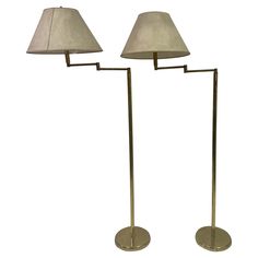 two floor lamps with shades on them