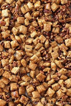 a pile of pecans sitting on top of a metal pan filled with food items