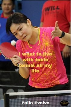 a woman holding a ping pong racket in her hand