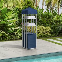 a blue and white umbrella stands next to a swimming pool