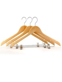 three wooden hangers with clips on them