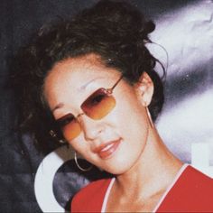 a woman with sunglasses on her face posing for the camera