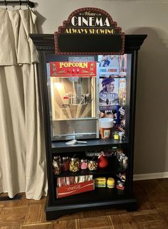 an old fashioned popcorn vending machine is on display in the corner of a room