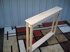 a wooden shelf sitting on top of a rug