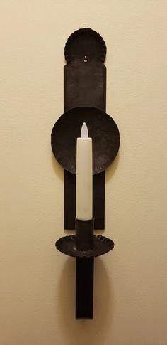 a candle that is sitting on a wall