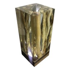 a glass vase that has some branches in it