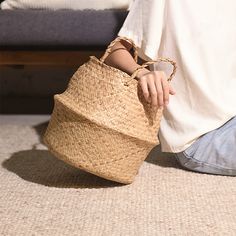 a person sitting on the floor with a basket