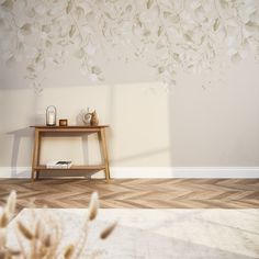 an empty room with a table and vases on the floor next to a wall