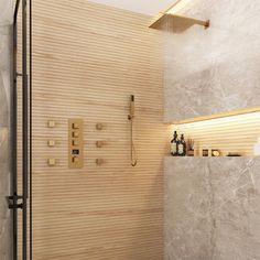 a bathroom with a walk in shower next to a tiled wall and wooden flooring