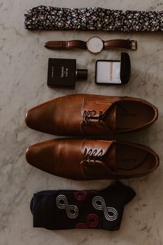 men's accessories laid out on a marble surface