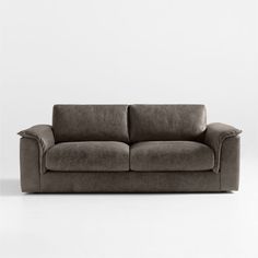 a brown couch sitting on top of a white floor