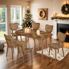 a dining room table and chairs with candles on the table in front of a fireplace