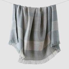 a gray and white checkered blanket hanging on a clothes line