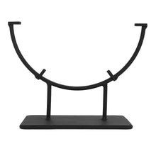 a black metal stand with two hooks on it's sides and one hook in the middle