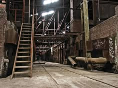 an old warehouse with stairs and graffiti on the walls