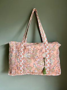 Very beautiful handmade cotton quilted bag, ideal for a lots of different situations. Has pockets on outside, zip up closure, tassel detail on the zip. Long straps for carrying on the shoulder.  47cm wide 10cm deep 32cm high Ideal for travel, carry on bag, hospital visits, baby bag.  Soft Coral Pink & Green Multicolor Tote Shoulder Bag For Overnight Trips, Pink Rectangular Shoulder Bag For Overnight Trips, Cotton Rectangular Diaper Bag For Travel, Cotton Travel Pouch Bag, Quilted Rectangular Travel Bag For Everyday Use, Rectangular Cotton Weekender Bag For Overnight Trips, Everyday Quilted Rectangular Travel Bag, Multicolor Quilted Travel Bag, Travel Quilted Cotton Shoulder Bag