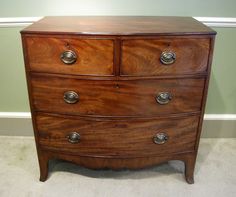 a wooden chest of drawers in a room