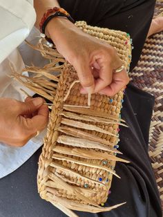 a person holding a basket made out of sticks