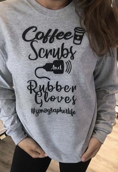 a woman wearing a sweatshirt that says coffee scrubs and rubber gloves