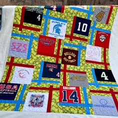 a quilt made to look like a baseball field with patches and numbers on the side