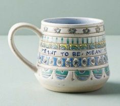 a coffee cup with words painted on it