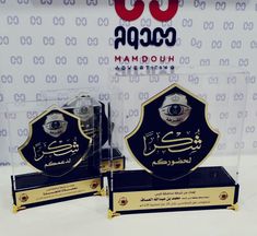 two trophies with arabic writing on them