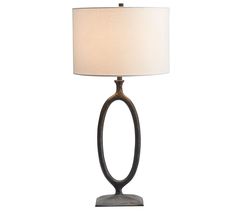 a table lamp with a white shade on it and a wooden base in the shape of an oval