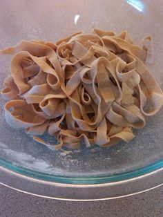 a pile of uncooked noodles in a glass bowl