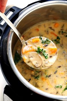 the best cozy autumn wild rice soup in a crock pot with a ladle