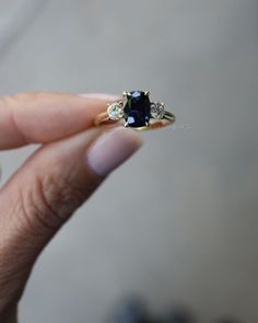 Blue Sapphire Three Stone Engagement Ring, Cushion Solitaire Wedding Ring Gift For Her, Vintage Solid Gold Sapphire and Moissanite Ring, Luxury Blue Sapphire Ring, Sapphire Ring, Rings For Her, Yellow Gold Ring, Elongated Cushion ring, Three Stone Sapphire Ring  𝐃𝐞𝐬𝐜𝐫𝐢𝐩𝐭𝐢𝐨𝐧 𝐨𝐟 𝐑𝐢𝐧𝐠 ● Sapphire Blue (Lab Created) Diamond Details:  → Center Stone Shape: Cushion Cut  → Center Stone Size:  1.80CT → Center Stone Measurement: 9*6.5mm ● Moissanite Details → Side Stone Shape: Round Cut  → Side Stone Size: 0.72ct  → Side Stone Measurement: 4.5mm ; 0.36ct ; 2 pcs → Stone Color: Colorless → Stone Clarity: VVS → Mohs Scale : Moissanite 9.25 → Refractive Index : 2.65 (Moissanite) → Total Stone Size: 2.52CTW  ● 𝐌𝐞𝐭𝐚𝐥 𝐃𝐞𝐭𝐚𝐢𝐥𝐬 → Metal type: Gold → Metal Purity: 14 KT → Metal To Cushion Sapphire Engagement Ring, Black Sapphire Engagement Ring, Kate Ring, Three Stone Sapphire Ring, Ring Saphir, Cushion Solitaire, Engagement Ring Cushion, Ring Luxury, Saphir Ring